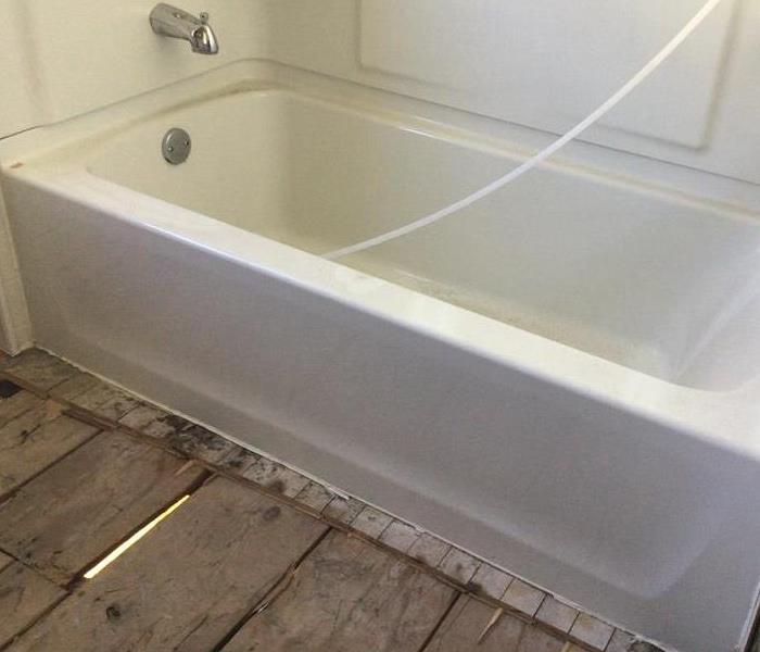 Picture of the same bathtub with the ice removed and resulting water damage mitigated
