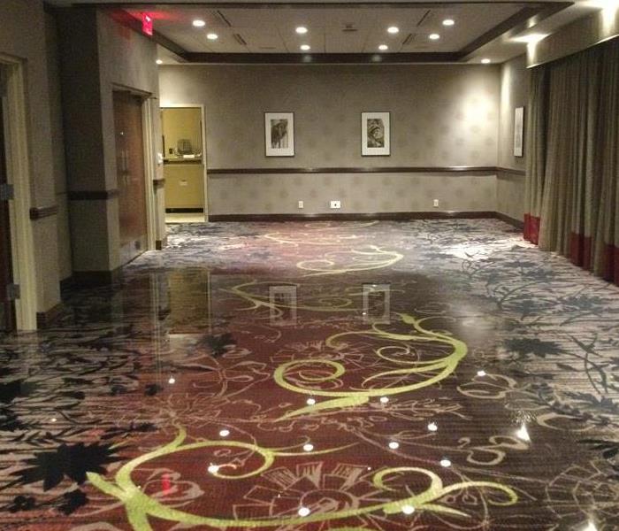 Picture of standing water on carpet in a hotel conference room